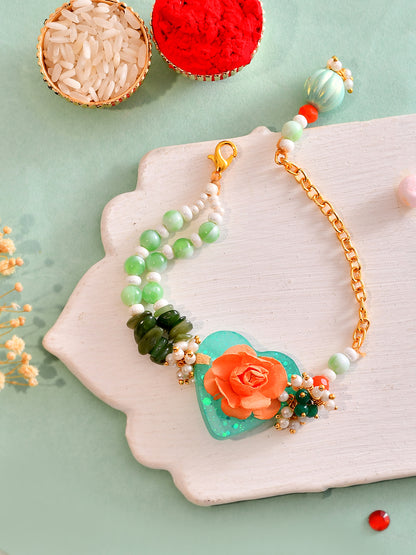 Green Heart Floral Resin Rakhi with Orange Rose