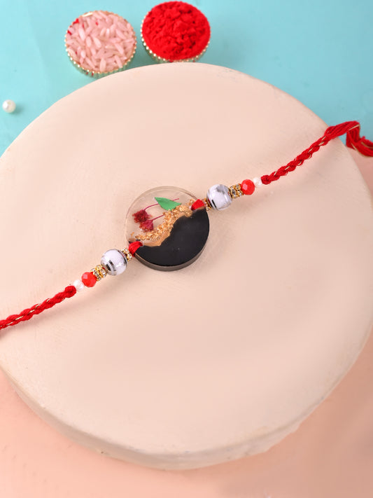 Black & Gold Resin Rakhi with Red Thread and Miniature Garden Scene