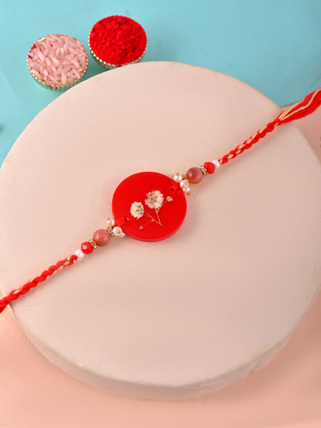 Minimal Red Floral Resin Rakhi with White Baby’s Breath