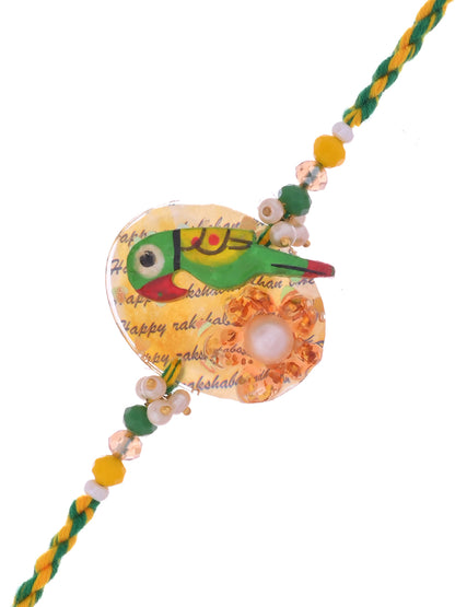 A Rakhi with a colorful parrot motif, featuring beads and a yellow-green thread.