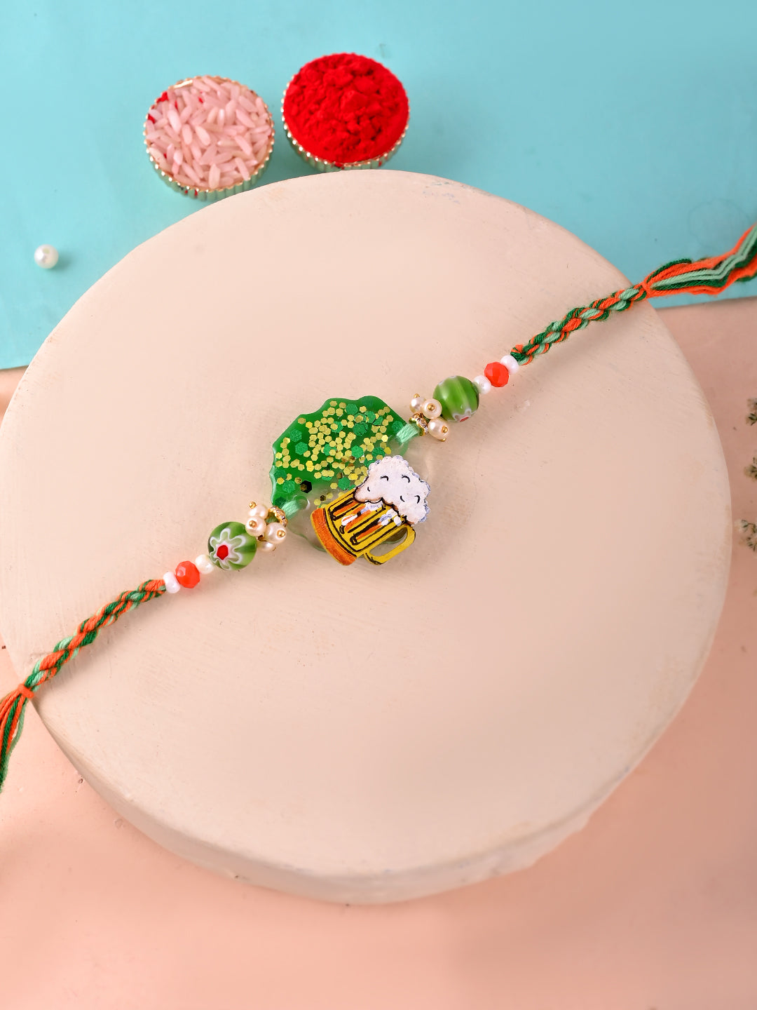 A quirky Rakhi with a beer mug and greenery design, reflecting a fun and casual style.