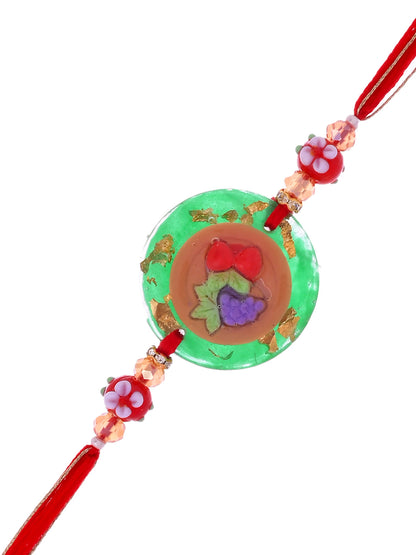 A Rakhi with a fruit plate design, likely symbolizing health or a festive theme.
