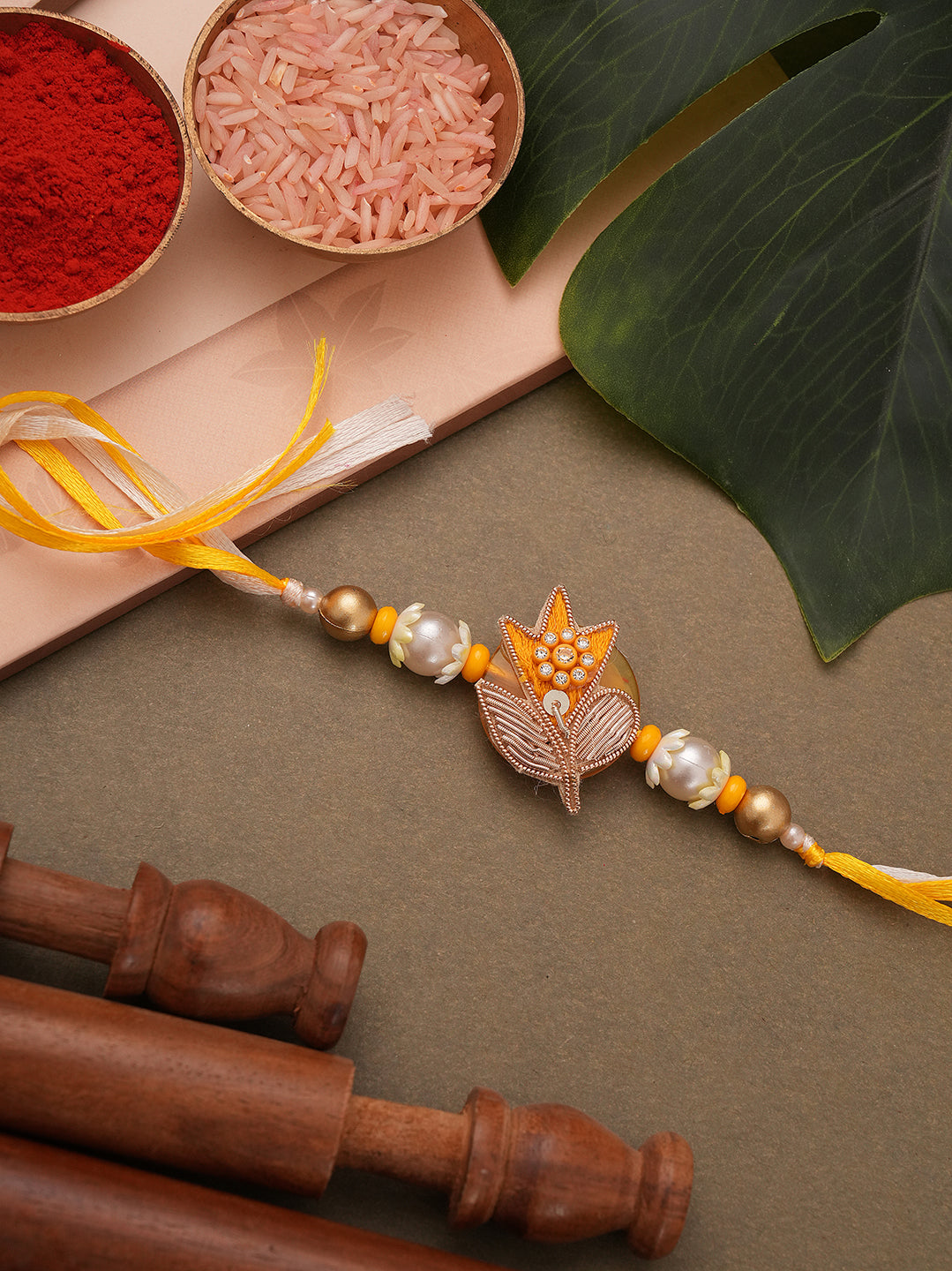 Elegant Floral Pearl Rakhi with Golden Accents