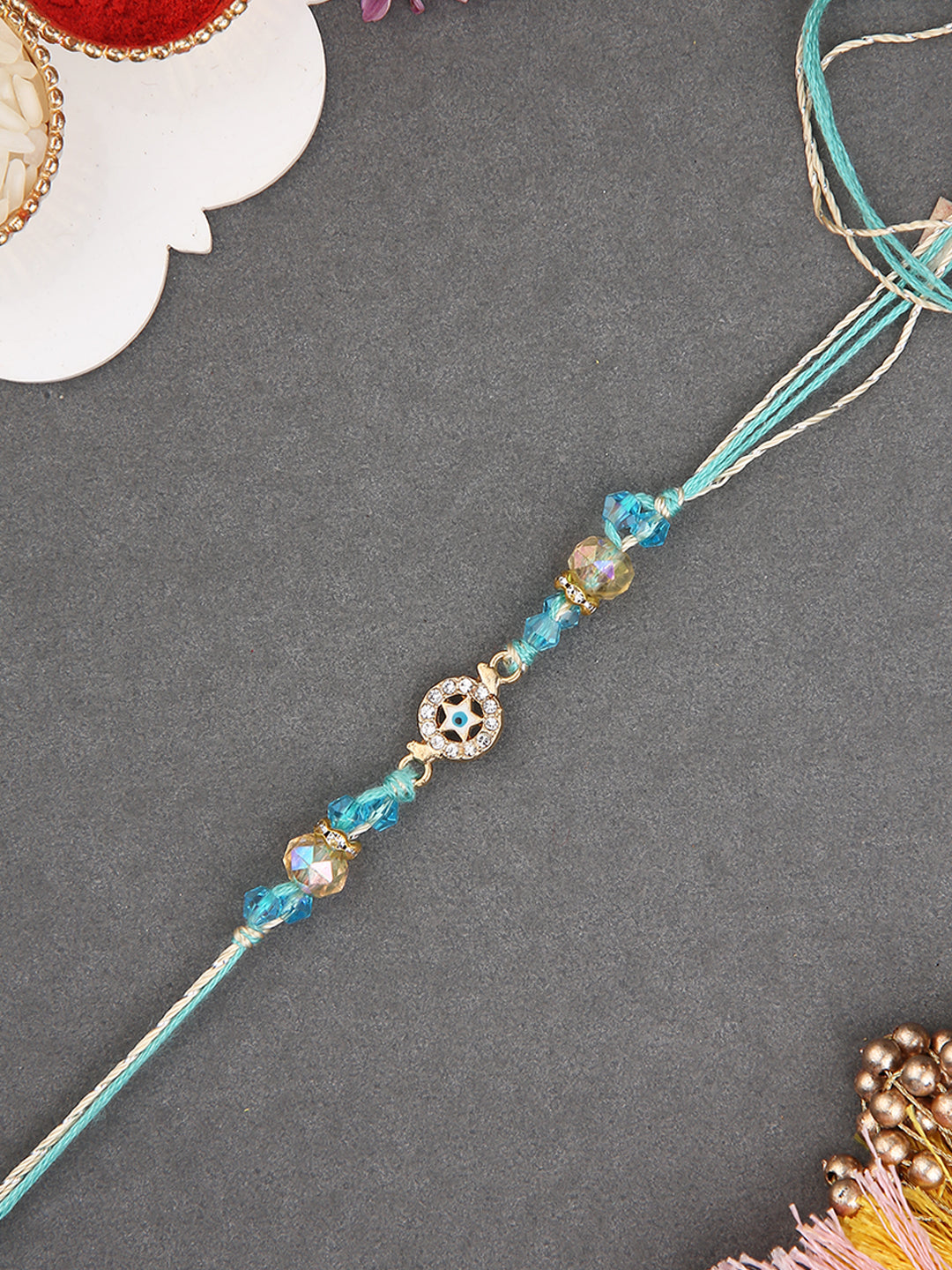 Handmade Evil Eye Rakhi with Aqua Blue Threads and Beads