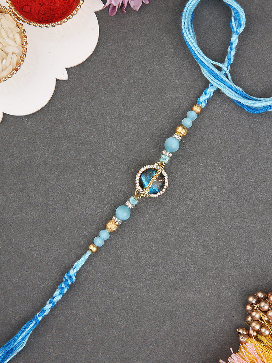 Handcrafted  Floral-Inspired Rakhi with Blue Center Stone and Pastel Beads