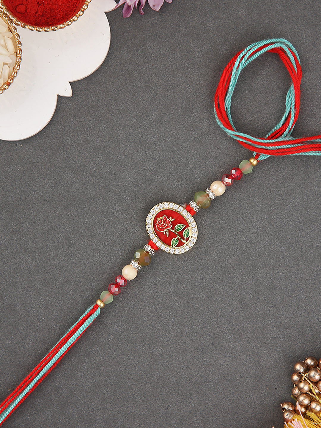 Festive Oval Rakhi with Enamel Detailing and Beaded Thread