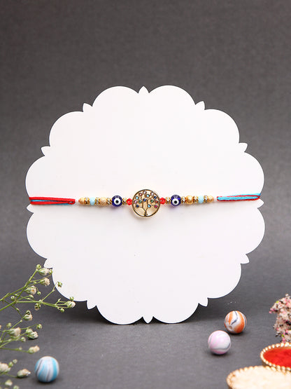 A more elegant Rakhi with a tree of life motif, embellished with colorful stones and beads