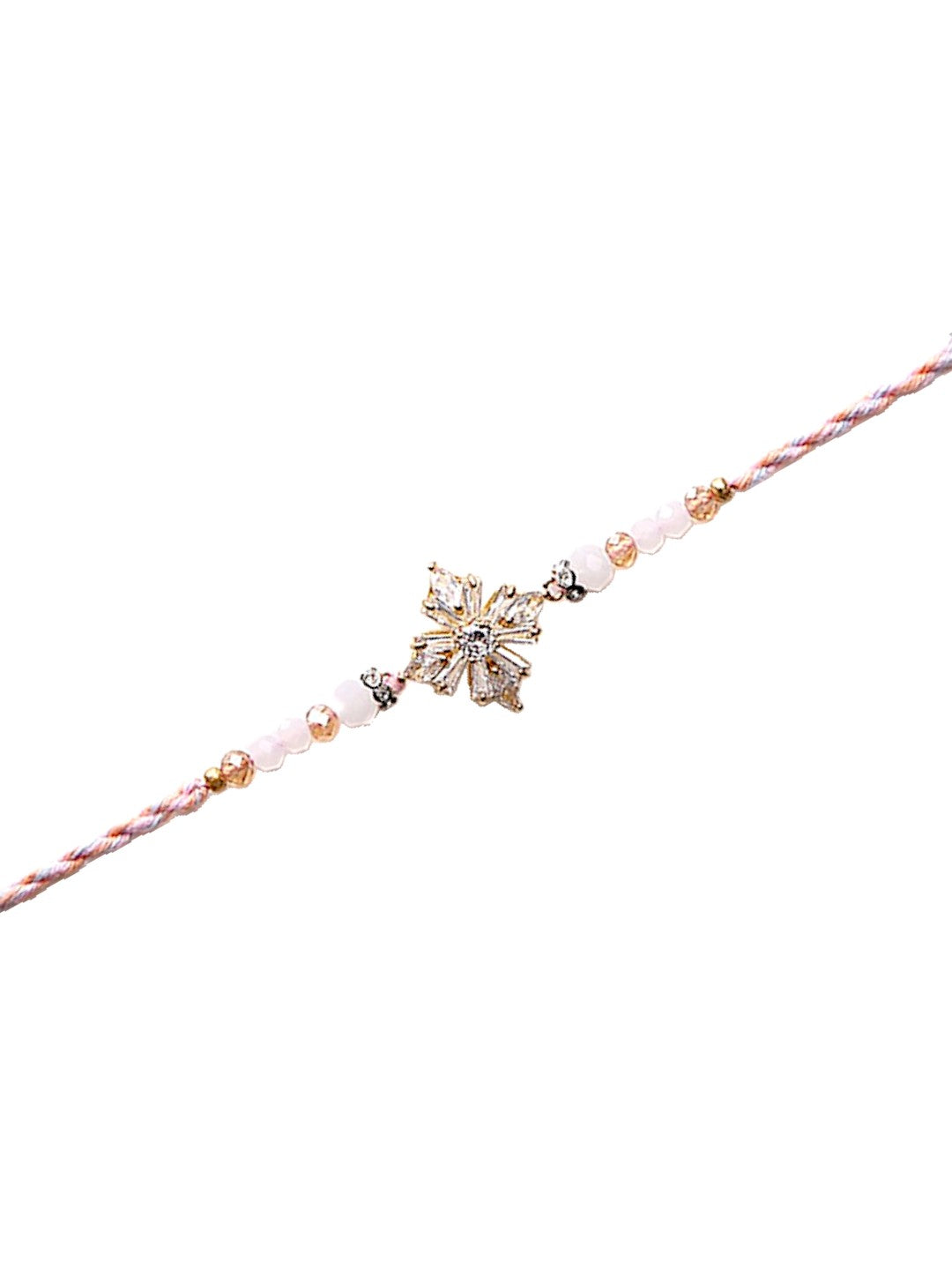 A minimalistic yet elegant Rakhi featuring a floral or star-shaped central piece with pastel