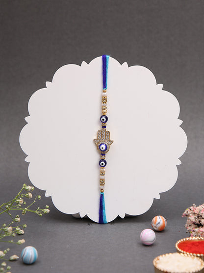 A blue thread Rakhi with a Hamsa hand and evil eye charms,