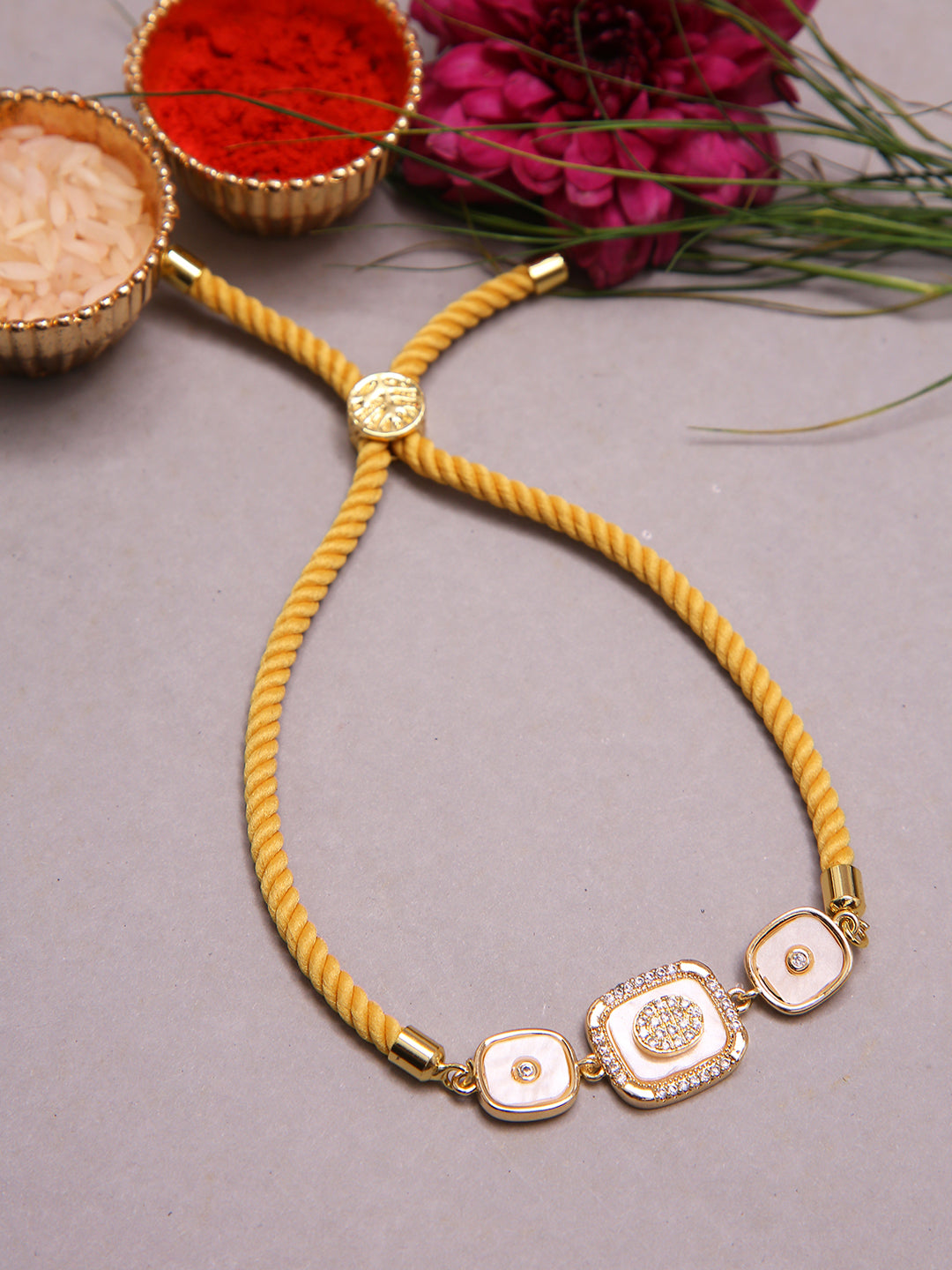 Handmade Festive Rakhi With Yellow Cord And Royal Trio Centerpiece