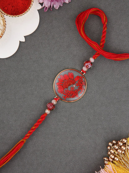 Artisanal Floral Resin Rakhi With Handcrafted Orange Thread And Rustic Beads
