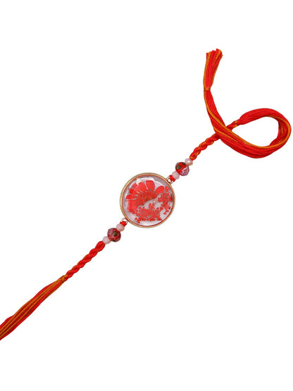 Artisanal Floral Resin Rakhi With Handcrafted Orange Thread And Rustic Beads