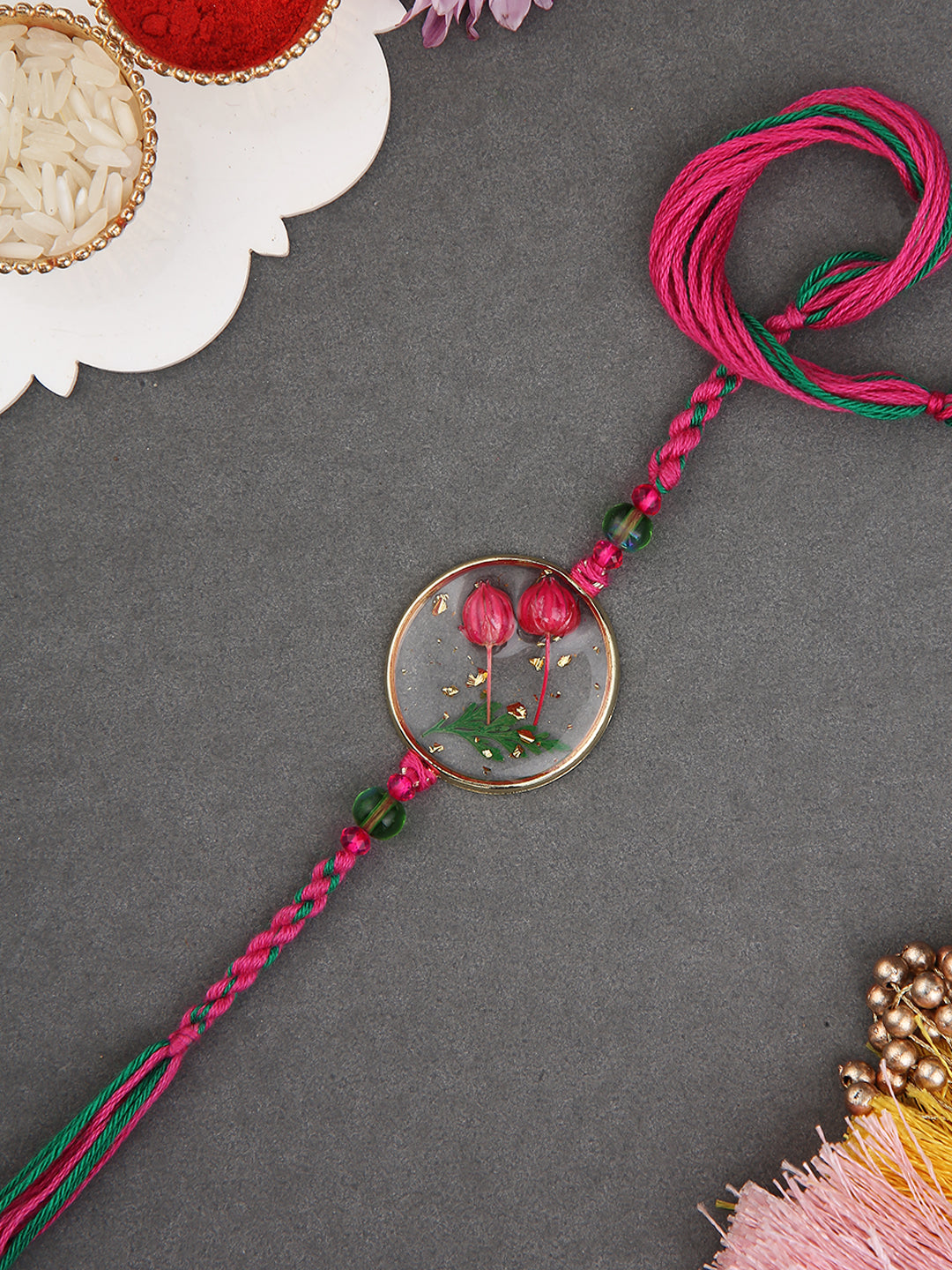 Preserved Botanical Rakhi With Dual Pink Buds And Handwoven Thread Work