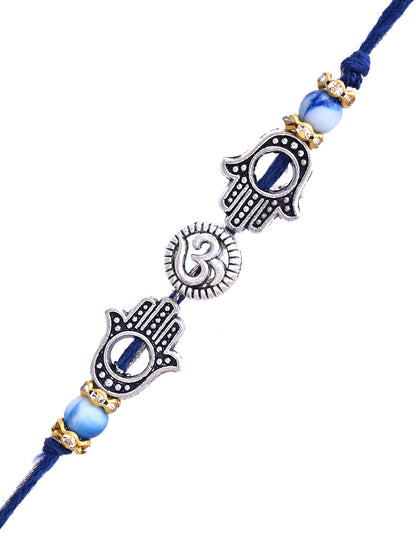 A Rakhi with double Hamsa hands and a central heart sun motif, with silver and blue accents.