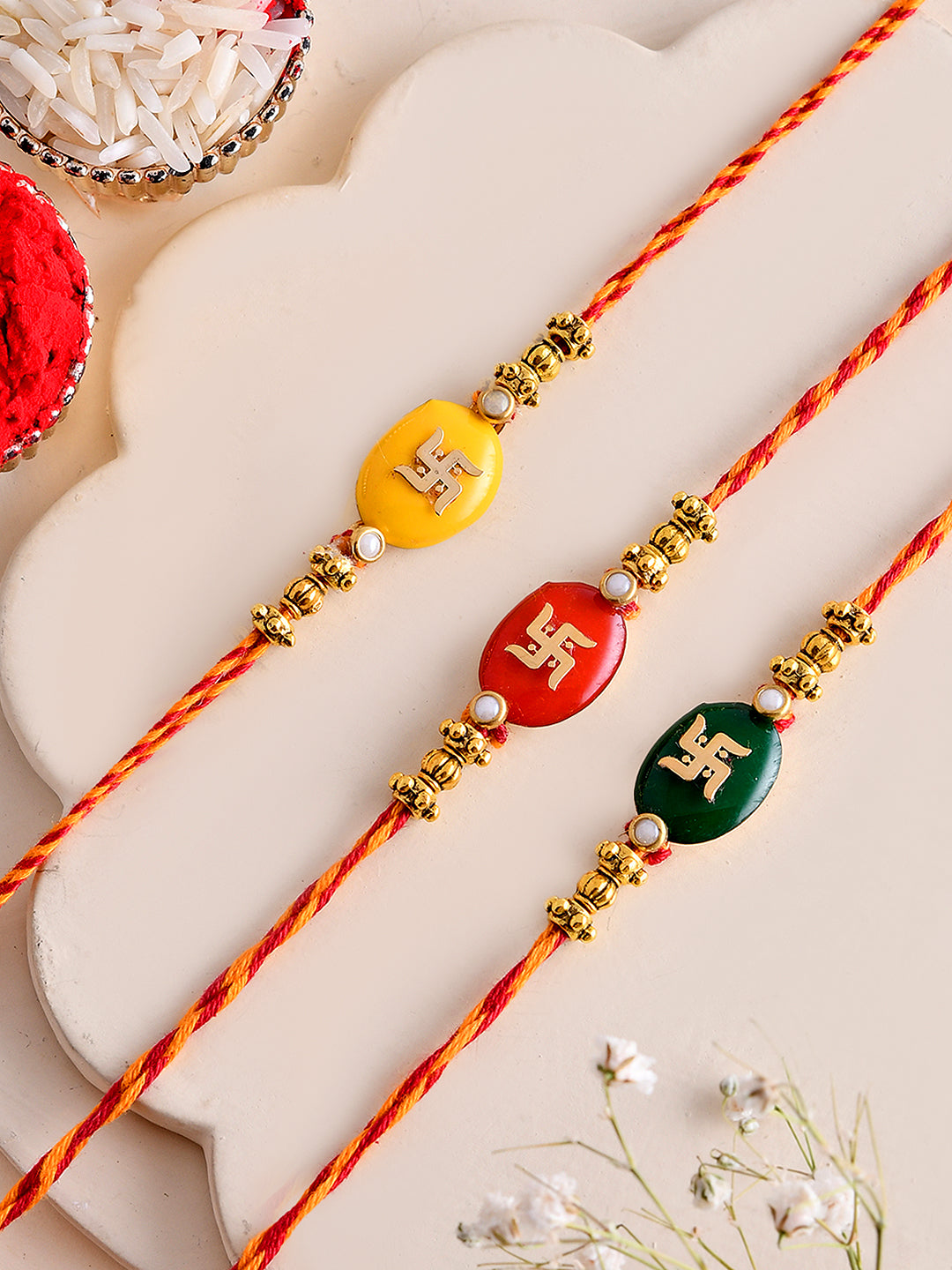Handcrafted Swastik Rakhi Trio in Festive Red, Yellow & GREEN Mauli Thread