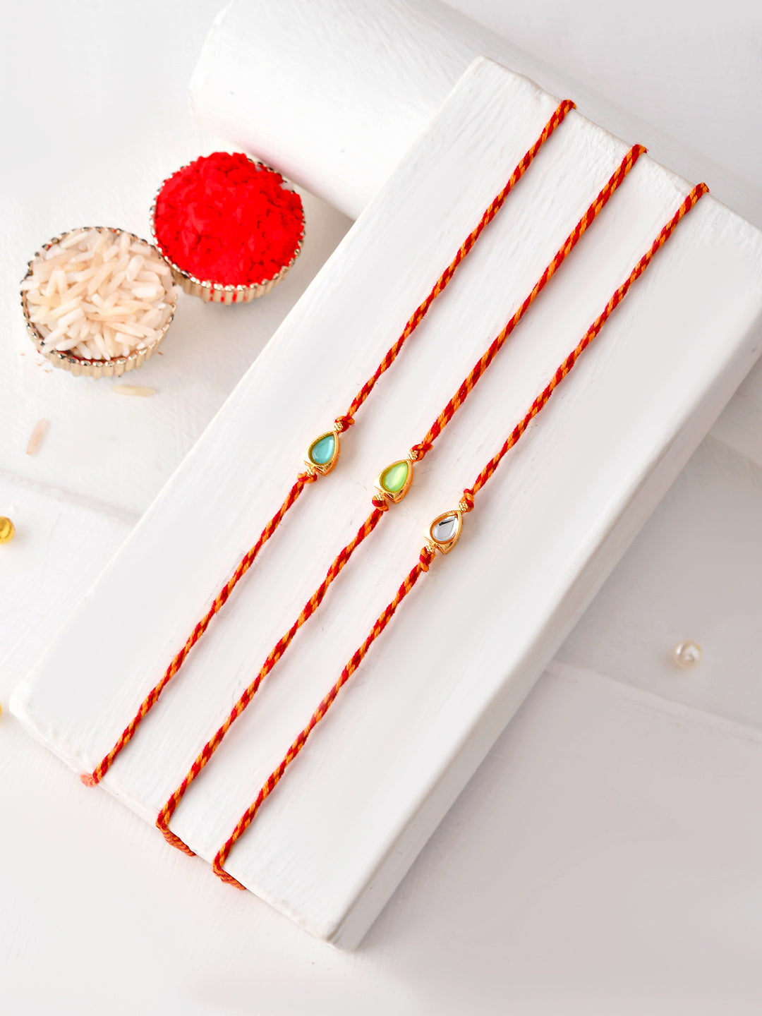 Subtle Kundan Rakhi Set of 3 with Teardrop Stone Design