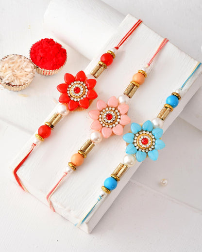 Vibrant Floral Rakhi Set of 3 for Brother with Red Pink Blue Accents