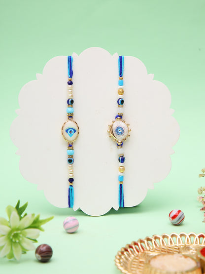 Set Of 2 Elegant Evil Eye Rakhis With Gold Outlined Motifs And Blue Beads