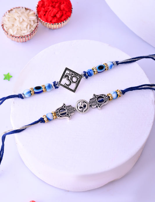 Set of two blue Rakhis, one with a Om symbol, and another with Hamsa hands,