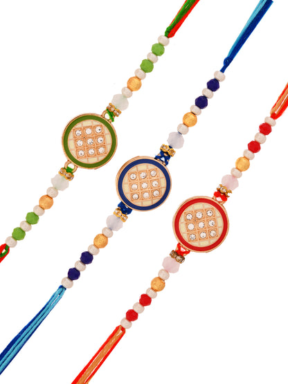 Trio of stone-studded Rakhis in green, red, and blue.