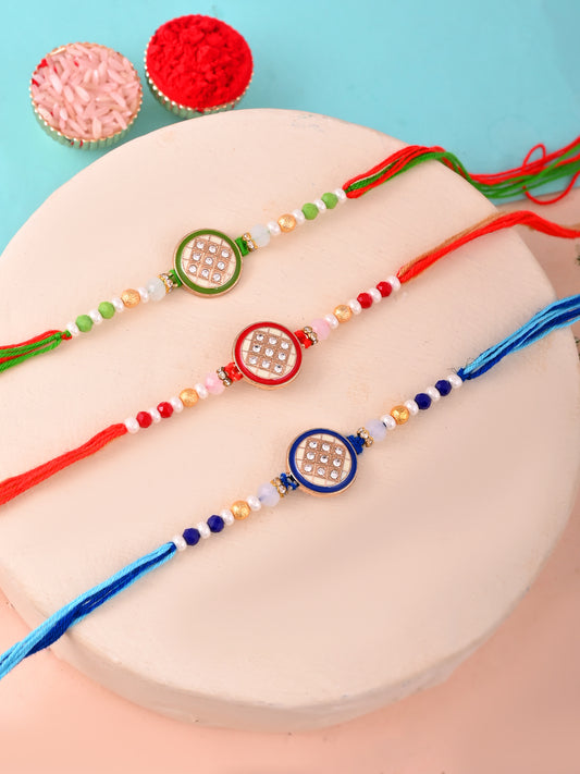 Trio of stone-studded Rakhis in green, red, and blue.