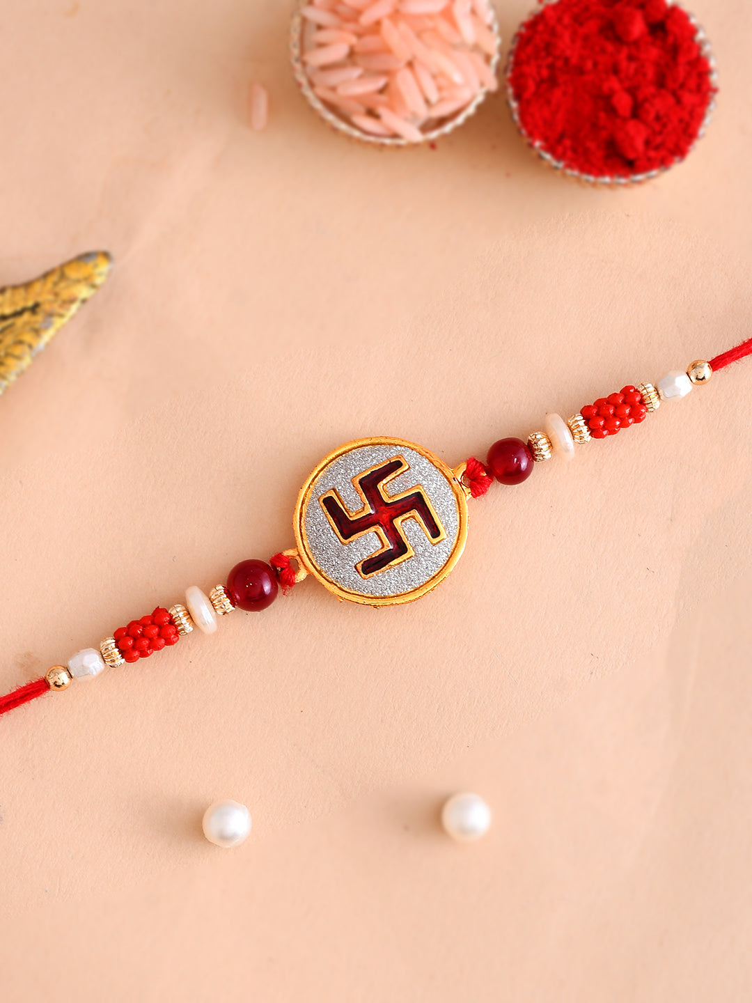 White Cylindrical Beads Studded Swastik Motif Rakhi
