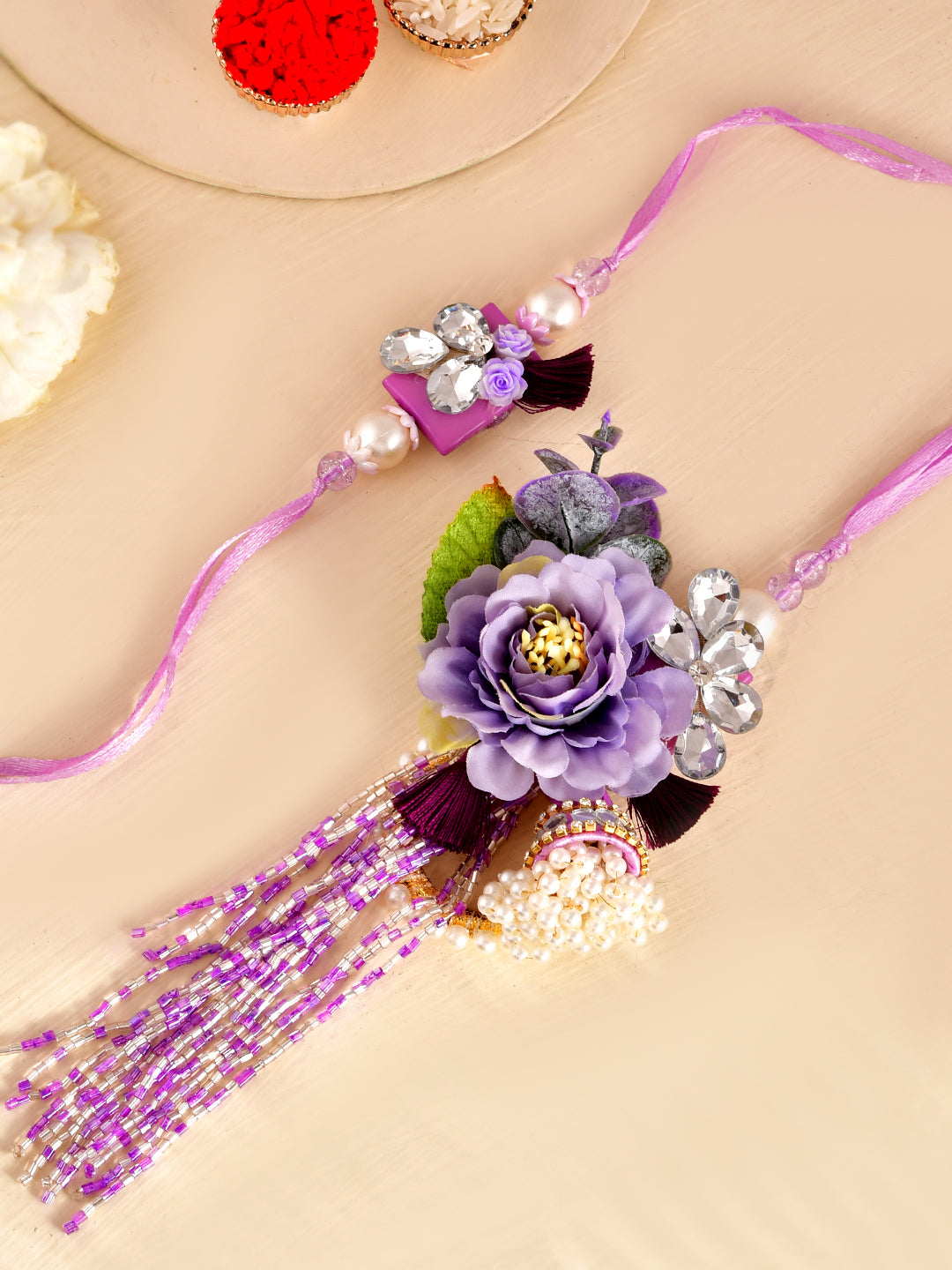 Purple Blossom Bhaiya Bhabhi Rakhi Set with Floral Embellishments and Beaded Tassels With Box