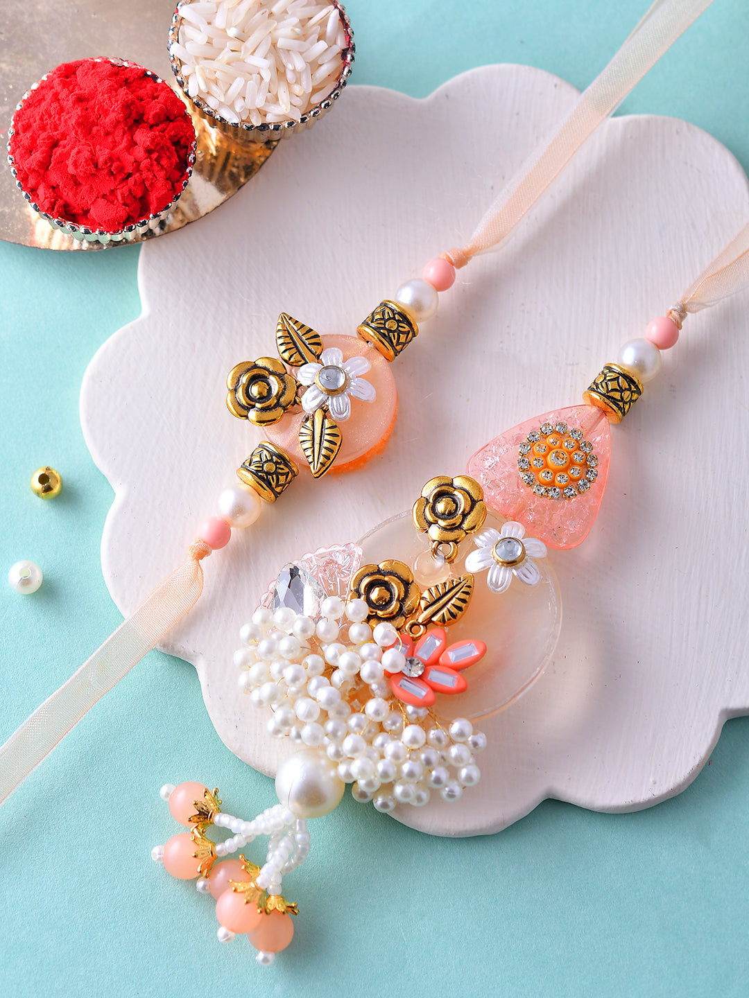 Elegant Peach Bhaiya Bhabhi Rakhi Set with Pearl Tassels and Golden Rose Work