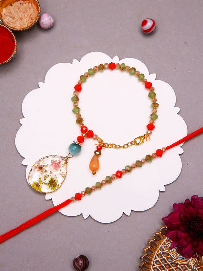 Handcrafted Rakhi Bracelet Set With Botanical Charm And Multicolor Stonework