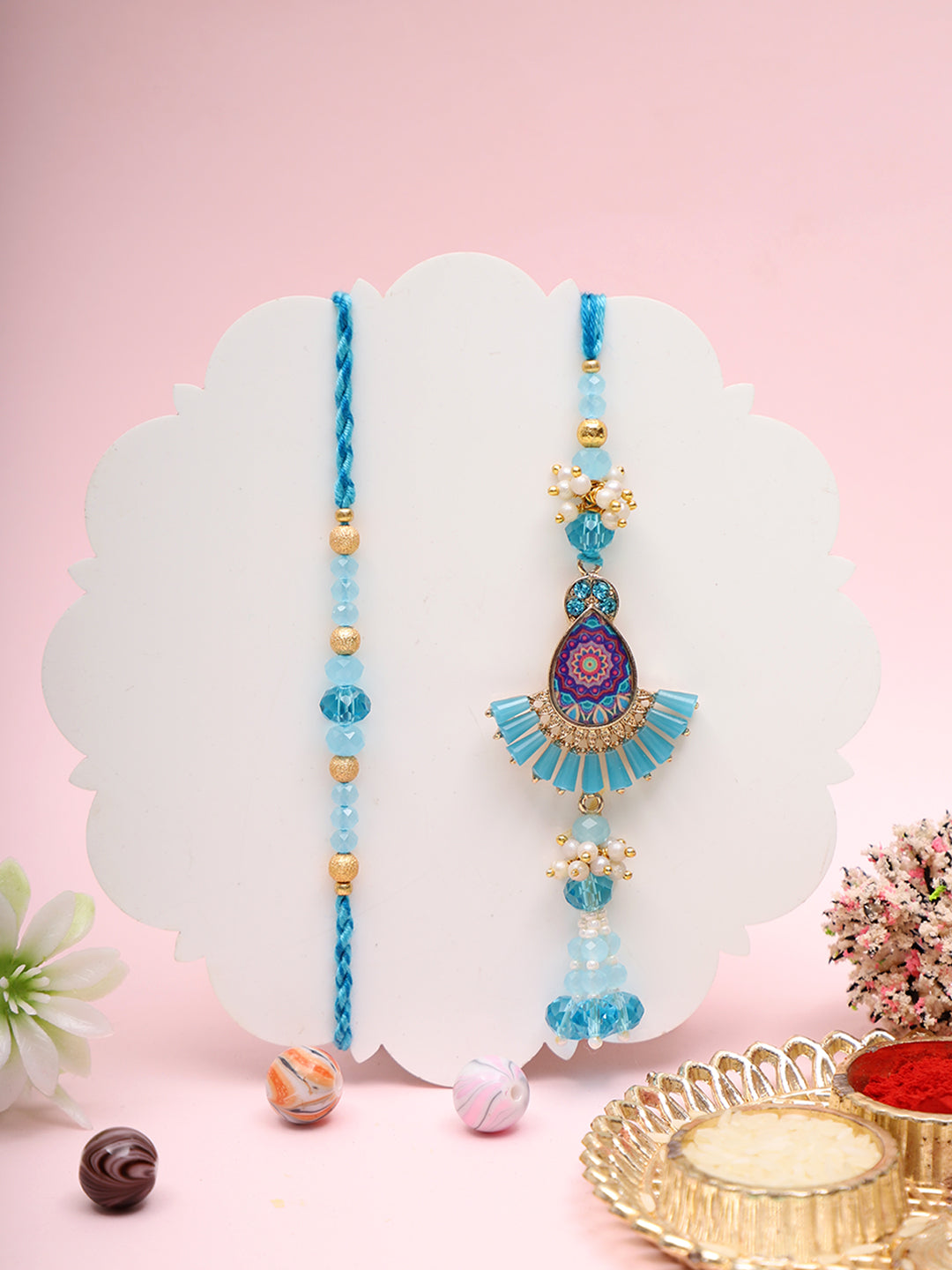 Blue Rakhi with fan-shaped locket and jute thali