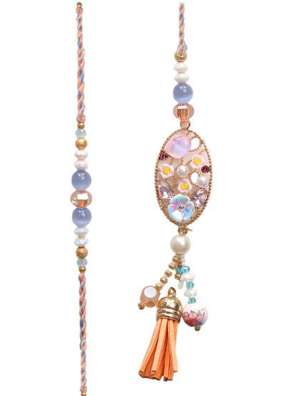 Soft-toned Rakhi set with peach accents and jute thali