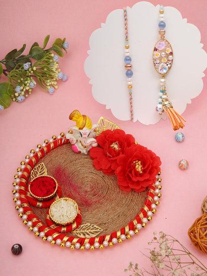Soft-toned Rakhi set with peach accents and jute thali